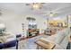 Bright living room with hardwood floors, modern decor, a flatscreen television, and an open layout to the kitchen at 2014 Basildon Rd, Mount Pleasant, SC 29466