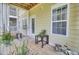Charming patio with wood floors, green siding, and plants, perfect for a relaxing outdoor experience at 2014 Basildon Rd, Mount Pleasant, SC 29466