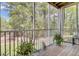 Inviting screened-in porch featuring wood flooring and a view of lush greenery, promoting relaxation at 2014 Basildon Rd, Mount Pleasant, SC 29466