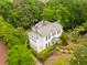 High-angle view of a stately home with pristine landscaping, complemented by mature trees and lush foliage at 2158 Westrivers Rd, Charleston, SC 29412