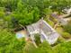 Elevated shot of an estate featuring a pool and beautiful landscaping, set amidst lush green surroundings at 2158 Westrivers Rd, Charleston, SC 29412