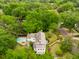 Aerial view of a stunning home, pool, and lush landscape bordered by mature trees at 2158 Westrivers Rd, Charleston, SC 29412