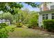 Beautiful backyard with stepping stone path, manicured lawn, and mature trees at 2158 Westrivers Rd, Charleston, SC 29412