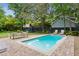 Backyard with a refreshing pool, patio seating, a play structure, and plenty of green space for outdoor activities at 2158 Westrivers Rd, Charleston, SC 29412