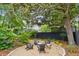Cozy backyard patio area with gravel base, outdoor seating, and mature shade tree at 2158 Westrivers Rd, Charleston, SC 29412