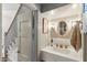 A stylishly designed bathroom with gold fixtures, marble countertop, and unique lighting at 2158 Westrivers Rd, Charleston, SC 29412