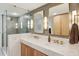 Bathroom with a glass shower, marble floors, modern fixtures, and a double sink vanity with gold accents at 2158 Westrivers Rd, Charleston, SC 29412
