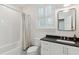Bathroom features subway tile, a tub, a toilet, and a dark stone vanity with bright mirror at 2158 Westrivers Rd, Charleston, SC 29412