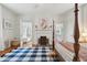 Bedroom boasts a four poster bed, fireplace, and adjacent seating area with bright windows at 2158 Westrivers Rd, Charleston, SC 29412