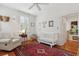Sun-lit bedroom featuring a ceiling fan, armchair, crib, and traditional red rug at 2158 Westrivers Rd, Charleston, SC 29412