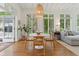 Bright dining area featuring hardwood floors, a round table with chairs, and views of the outdoor greenery at 2158 Westrivers Rd, Charleston, SC 29412
