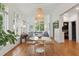 Bright dining area with hardwood floors, a round table, and a view into a cozy living space with a large grey sectional at 2158 Westrivers Rd, Charleston, SC 29412