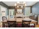 Elegant dining room with floral wallpaper, a wooden table, and a decorative chandelier at 2158 Westrivers Rd, Charleston, SC 29412