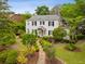 Charming two-story home with classic architectural details, lush landscaping, and a welcoming stone pathway at 2158 Westrivers Rd, Charleston, SC 29412