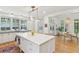 Spacious kitchen with a large island, white cabinets, and an open layout leading to a dining area at 2158 Westrivers Rd, Charleston, SC 29412
