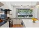 Bright, modern kitchen with a large island, marble countertops, and a window overlooking the backyard at 2158 Westrivers Rd, Charleston, SC 29412