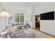 Bright, open living room featuring large windows and view into the dining room, creating an inviting and spacious atmosphere at 2158 Westrivers Rd, Charleston, SC 29412