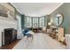 A spacious living room with bay windows, fireplace, hardwood floors and stylish decor at 2158 Westrivers Rd, Charleston, SC 29412