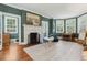 A bright living room with hardwood floors, a fireplace, bay windows, and stylish decor at 2158 Westrivers Rd, Charleston, SC 29412