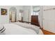 A naturally lit bedroom with a hardwood floor, chest of drawers, mirror and a doorway at 2158 Westrivers Rd, Charleston, SC 29412