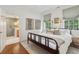 A naturally lit bedroom featuring a wood frame bed and an attached bathroom at 2158 Westrivers Rd, Charleston, SC 29412