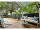 Relaxing covered patio with wicker furniture, decorative pillows, a hanging swing, and a view of the inviting pool at 2158 Westrivers Rd, Charleston, SC 29412