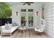 Inviting outdoor patio with comfortable seating, hanging swing, and charming decor, perfect for relaxing by the pool at 2158 Westrivers Rd, Charleston, SC 29412