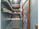 Organized pantry featuring shelving, drawers, marble countertop, jars, and baskets at 2158 Westrivers Rd, Charleston, SC 29412