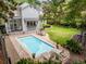 Inviting backyard pool area with lounge chairs, dining, and a covered patio, ideal for outdoor relaxation at 2158 Westrivers Rd, Charleston, SC 29412