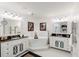 Bright white bathroom showcasing double vanities, a soaking tub, and elegant finishes at 222 S Plaza Ct, Mount Pleasant, SC 29464