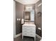 Elegant bathroom with a white vanity, stylish mirror, and neutral paint at 222 S Plaza Ct, Mount Pleasant, SC 29464
