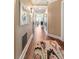 Long hallway with hardwood floors leads to a bright living area at 222 S Plaza Ct, Mount Pleasant, SC 29464