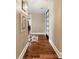 Light-filled hallway featuring hardwood floors and modern lighting fixtures at 222 S Plaza Ct, Mount Pleasant, SC 29464