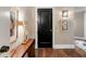Hallway with hardwood floors, lovely art, and a vintage side table at 222 S Plaza Ct, Mount Pleasant, SC 29464
