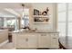 Kitchen wet bar featuring white cabinets, marble counters, open shelving, and stylish decor at 222 S Plaza Ct, Mount Pleasant, SC 29464