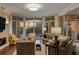 This well-lit living room has cozy seating, large windows, and elegant decor at 222 S Plaza Ct, Mount Pleasant, SC 29464