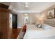 Comfortable main bedroom offering a view to the ensuite and features natural light and hardwood floors at 222 S Plaza Ct, Mount Pleasant, SC 29464