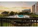Luxury condo view features a community pool, landscaping, and harbor bridge at 222 S Plaza Ct, Mount Pleasant, SC 29464