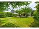 Expansive backyard featuring lush green lawn, mature trees, providing a serene outdoor space at 2254 Show Basket Way, Mount Pleasant, SC 29466