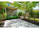 Beautiful backyard patio with a covered porch, lush landscaping, and stone tile flooring at 2254 Show Basket Way, Mount Pleasant, SC 29466