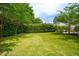 Spacious backyard with a lush green lawn, mature trees, and privacy hedges at 2254 Show Basket Way, Mount Pleasant, SC 29466