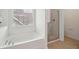 Bright bathroom featuring a modern soaking tub, and separate glass-enclosed shower at 2254 Show Basket Way, Mount Pleasant, SC 29466