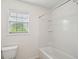 Clean white bathroom with a bathtub/shower combo and window at 2254 Show Basket Way, Mount Pleasant, SC 29466