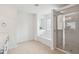 Bright bathroom features a soaking tub, glass-enclosed shower, and neutral tile flooring at 2254 Show Basket Way, Mount Pleasant, SC 29466