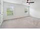 Large bedroom with neutral carpeting, two sunny windows, and a ceiling fan at 2254 Show Basket Way, Mount Pleasant, SC 29466