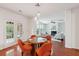Dining area with modern lighting fixtures, a wooden table with orange chairs, and french doors at 2254 Show Basket Way, Mount Pleasant, SC 29466