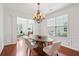 Inviting dining room bathed in natural light, featuring a hardwood floor and elegant chandelier at 2254 Show Basket Way, Mount Pleasant, SC 29466