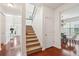 Entryway features carpeted stairs, hardwood floors, a coat closet, and view to the dining room at 2254 Show Basket Way, Mount Pleasant, SC 29466