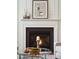Living room fireplace with white mantle, glass coffee table, and decorative vases and heron artwork at 2254 Show Basket Way, Mount Pleasant, SC 29466
