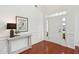 Warm and inviting foyer with a console table, decorative lamp, and wainscoting detail at 2254 Show Basket Way, Mount Pleasant, SC 29466